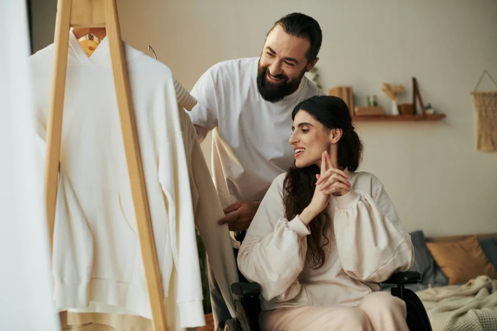 Disabled woman and her support worker choosing clothes together
