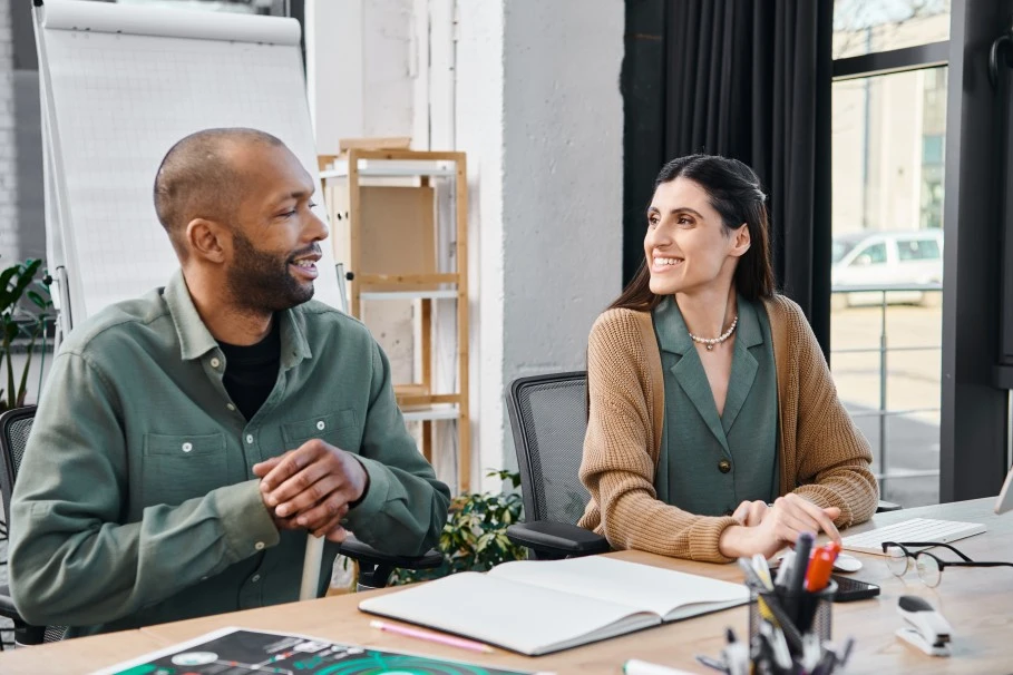 Disabled man and his support worker smiling while looking at each other